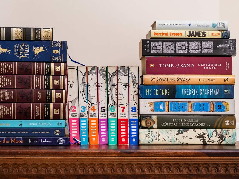 Three separate stacks of books showcase a diverse collection of fiction, non-fiction, graphic novels, and comics – Beautiful Homes Three separate stacks of books showcase a diverse collection of fiction, non-fiction, graphic novels, and comics – Beautiful Homes