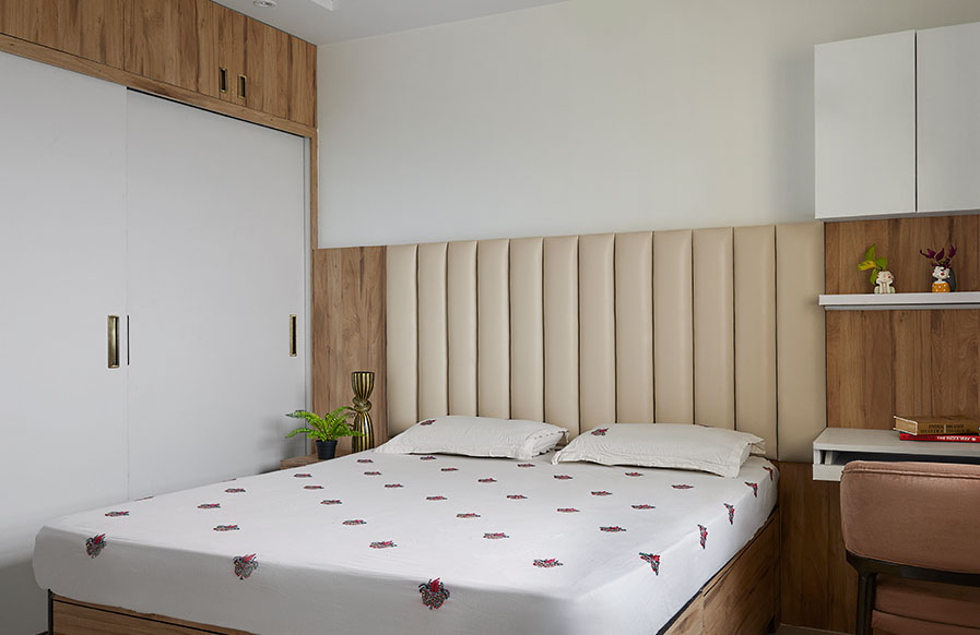 Escape into a Modern All-White Sanctuary - Beautiful Homes A modern all-white bedroom with a patterned wall and hanging pendant light - Beautiful Homes