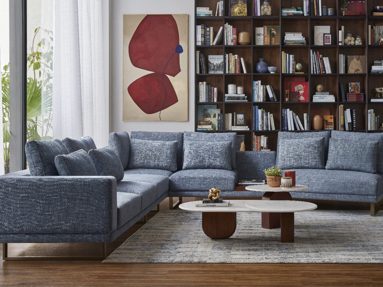 Modern Living Space with Wooden Bookshelf Living room with blue sofa and wooden bookshelf - Beautiful Homes