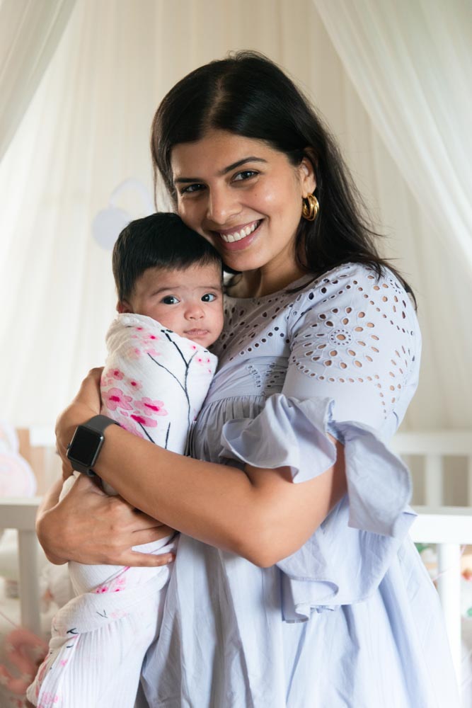 Designer Sarah Sham with her daughter in her arms Designer Sarah Sham with her daughter in her arms