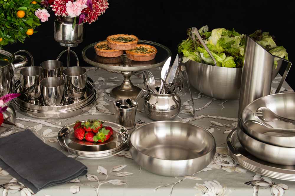 A table where are a lot of utensils have been placed next to each other