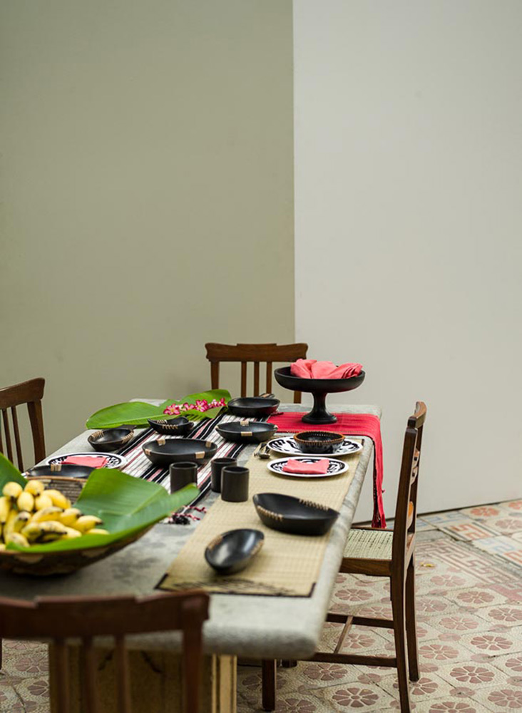 A wooden dining table and chairs with cutlery A wooden dining table and chairs with cutlery