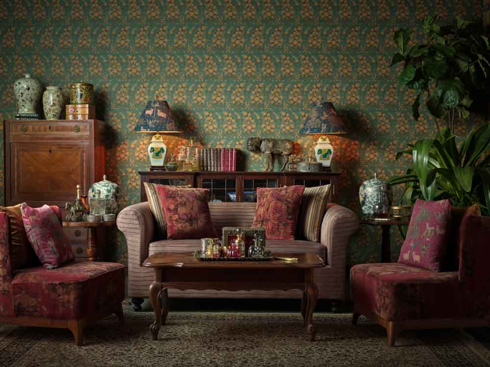 A living room with a green floral wallpaper