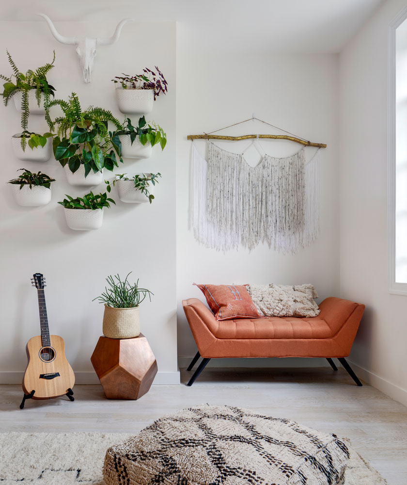A corner of a room with a bench covered in orange fabric and some plants hanging on the wall - Beautiful Homes A corner of a room with a bench covered in orange fabric and some plants hanging on the wall - Beautiful Homes