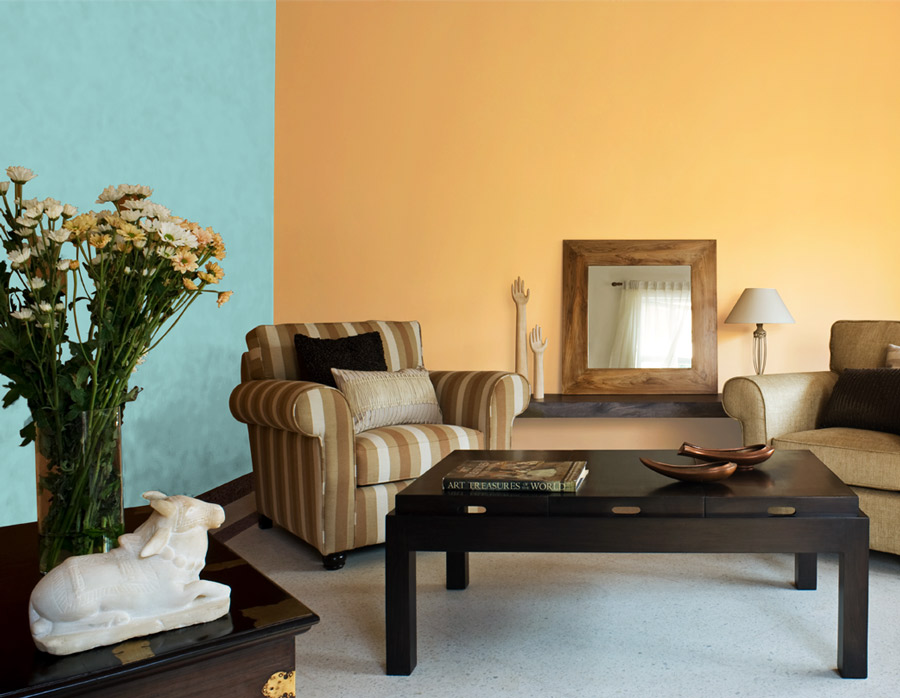 A living room painted in blue and yellow with two chairs and a large wooden centre table - Beautiful Homes A living room painted in blue and yellow with two chairs and a large wooden centre table - Beautiful Homes