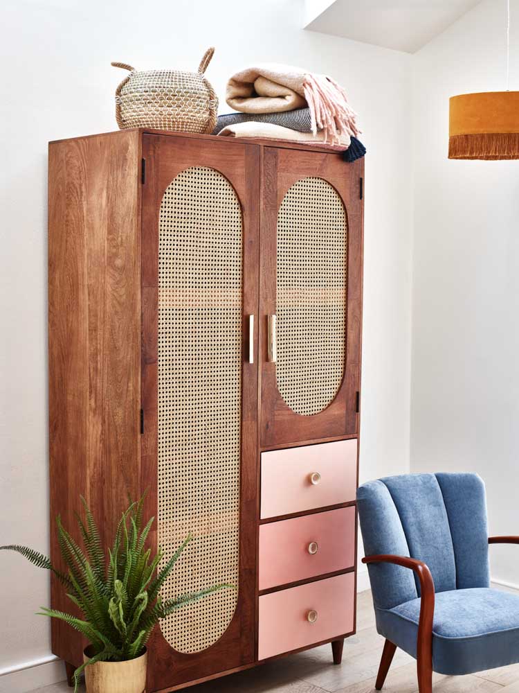 A rattan finish closet next to an armchair