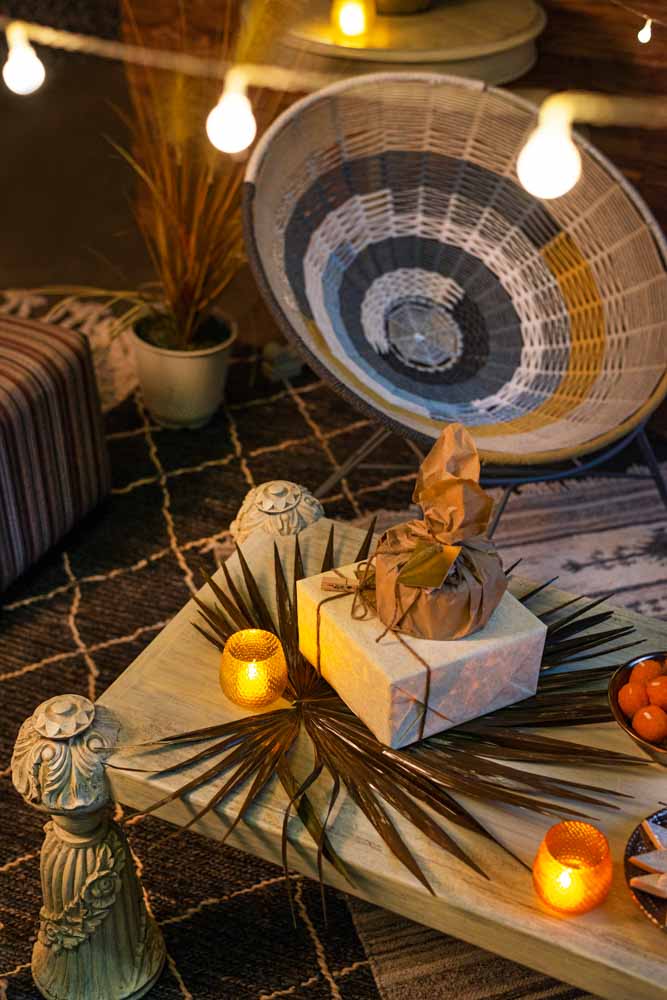 A corner of a coffee table with a packaged gift placed on it