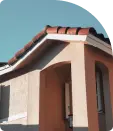 A home exterior with brown walls and terracotta roof tiles