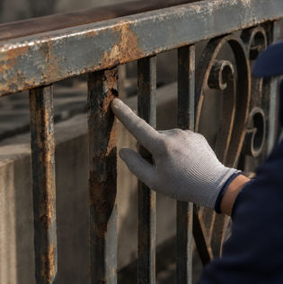 Inspecting Rusted Metal Surface Before Paint Preparation