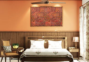 Warm and Inviting Master Bedroom with Tan Orange Wall