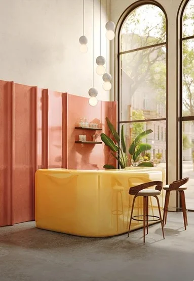 Living room with pink sofa and golden lamp with a plant placed in the corner