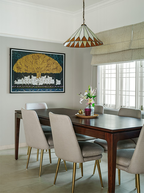Modern furnishings & a traditional Pichwai painting for dining room design - Beautiful Homes