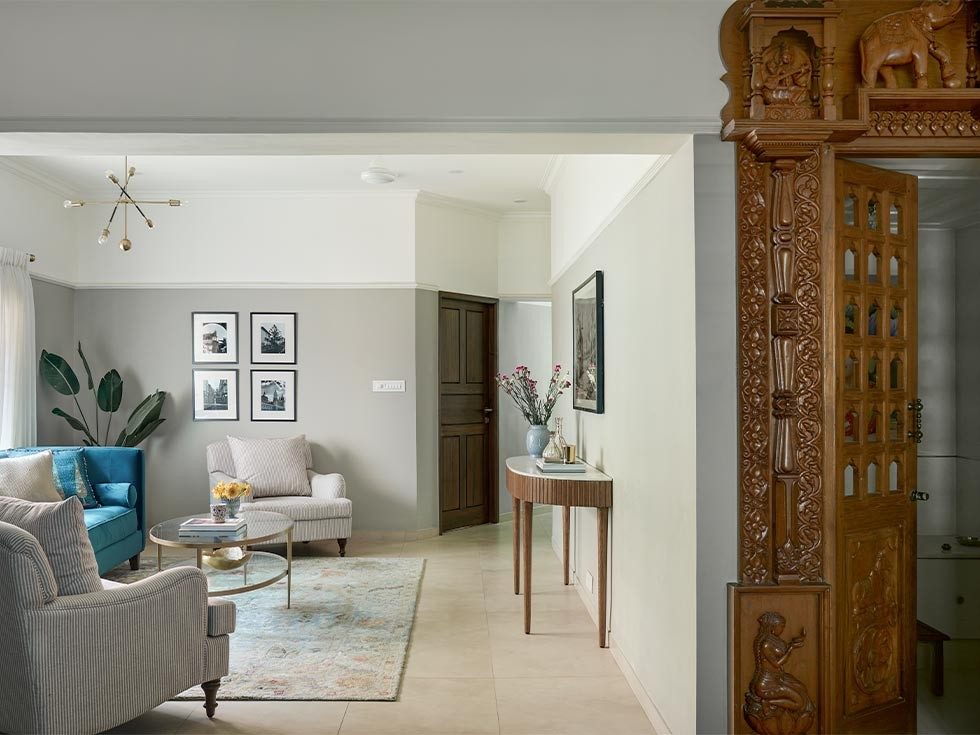Contemporary furniture & hand carved teak door that leads to the puja room for living room - Beautiful Homes