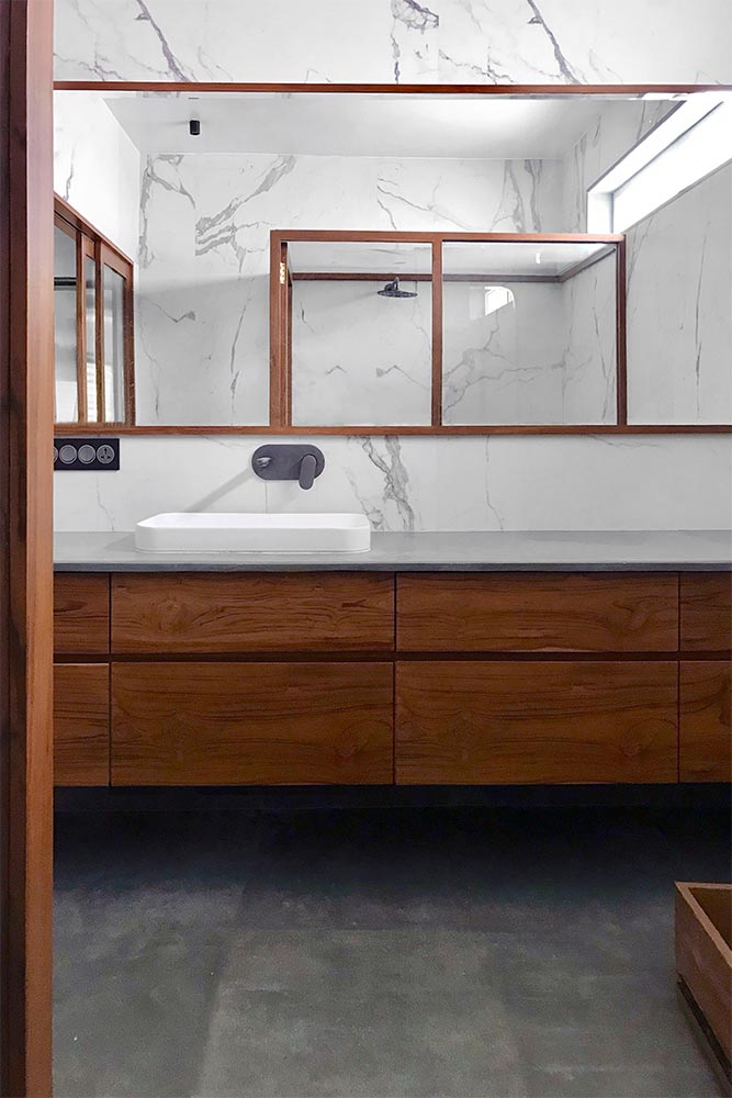 Bathroom design with marble tiles & wooden vanity - Beautiful Homes