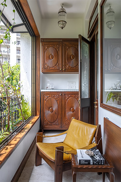 Balcony with wooden cabinets & armchair - Beautiful Homes