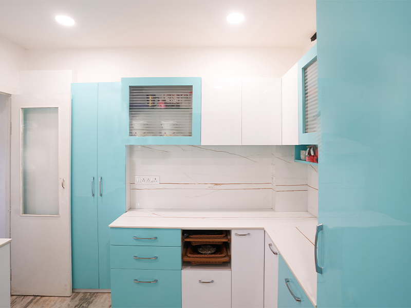 L-shaped kitchen design with white & turquoise colour combinations - Beautiful Homes