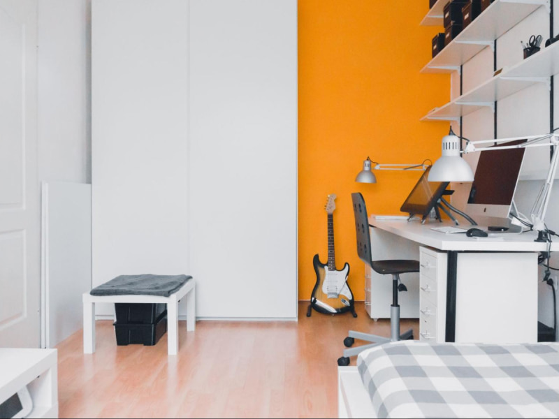 Orange bedroom walls with wall shelving - Beautiful Homes