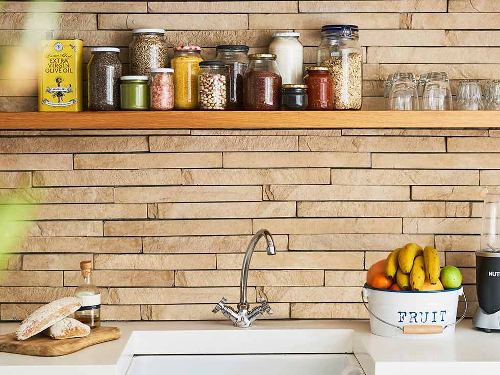 Open shelving in kitchen with brick wall panelling - Beautiful Homes
