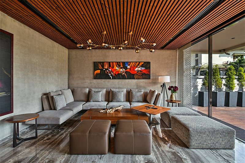 Wooden pvc ceiling design with a  chandelier in a luxury living room - Beautiful Homes