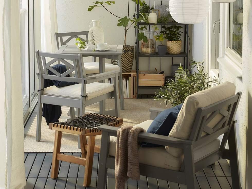 Balcony furniture idea with lounge chair & a seating nook - Beautiful Homes