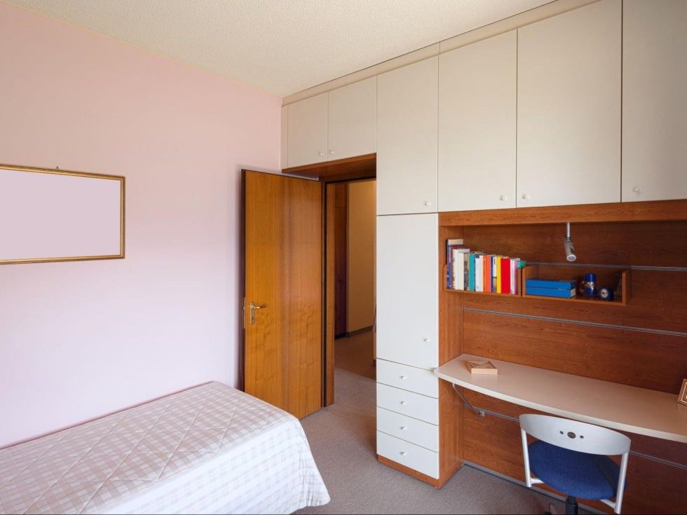 Wooden wardrobe with study table design in a simple bedroom - Beautiful Homes