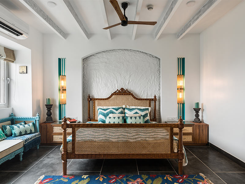 White painted bedroom with cane furniture gives a vintage look - Beautiful Homes