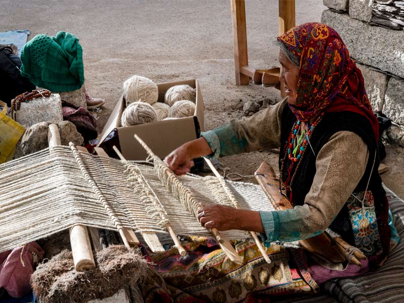 Women working on the loom to create handwoven products - Beautiful Homes