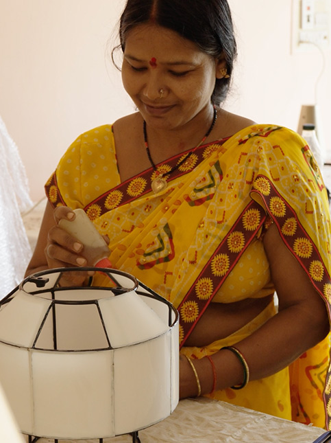 Artisan assembling sustainable lamp – Beautiful Homes