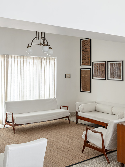 White Themed Sitting Room with Dark Brown Wooden Accents - Beautiful Homes