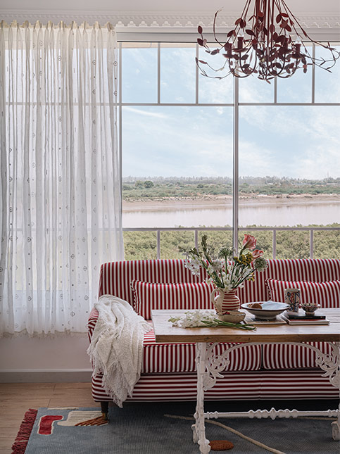 Red And White Stripped Sofa Near Window - Beautiful Homes