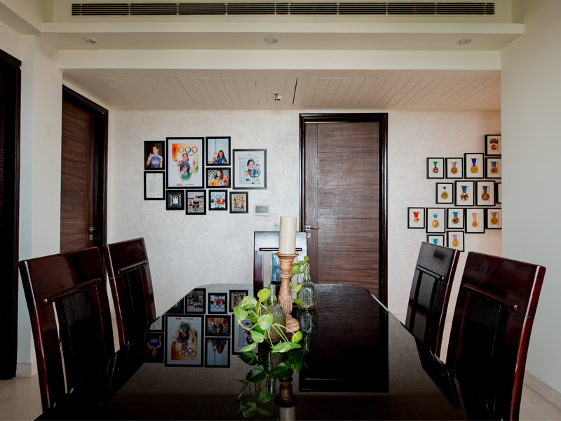 Dining table is framed by photographs – Beautiful Homes