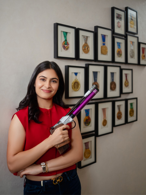 Manu poses by the wall of medals – Beautiful Homes