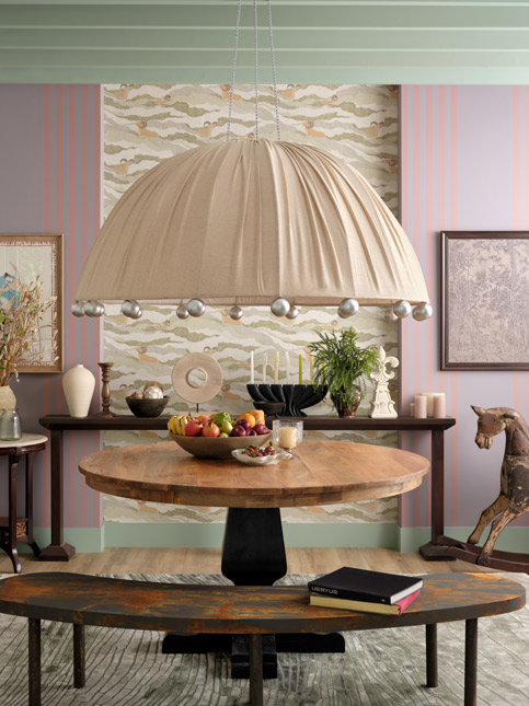 Dining area with a large, dome-shaped chandelier, wooden table, and eclectic décor - Beautiful Homes