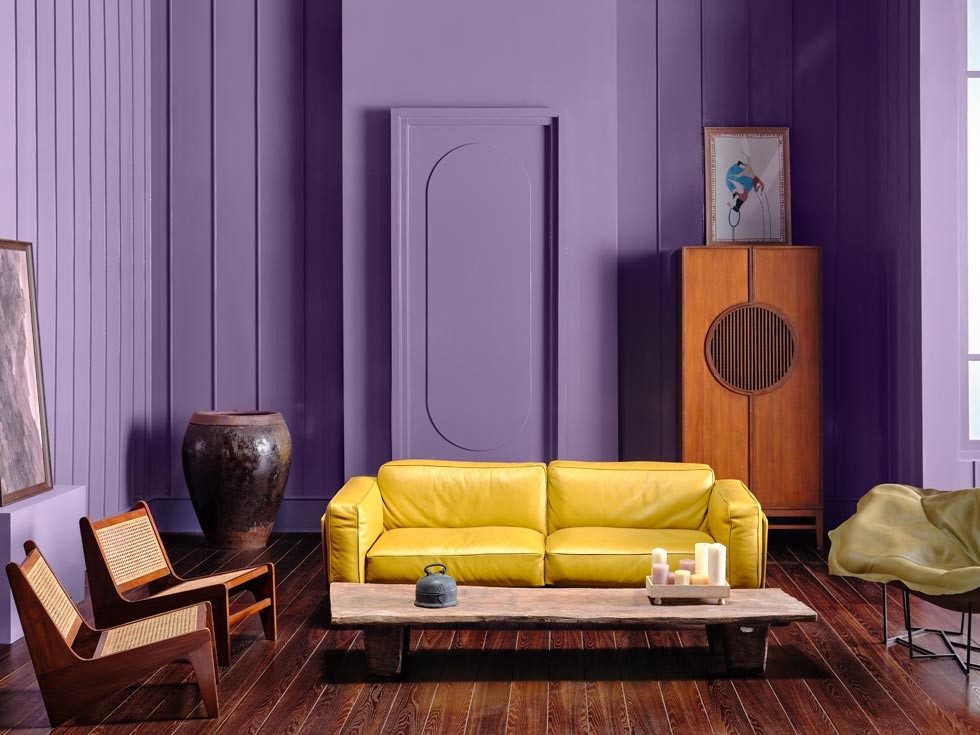 Yellow sofa in a purple room with eclectic décor - Beautiful Homes