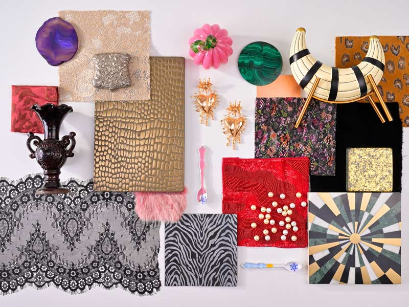 Assorted decorative items and fabrics in various textures and colours arranged on a surface – Beautiful Homes