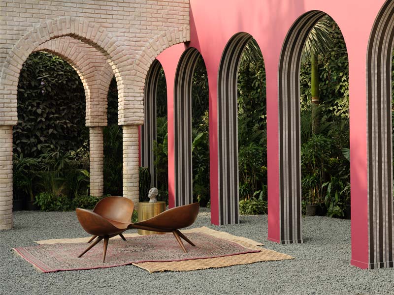 Outdoor space with arched pink walls, brick archways, and modern wooden seating – Beautiful Homes