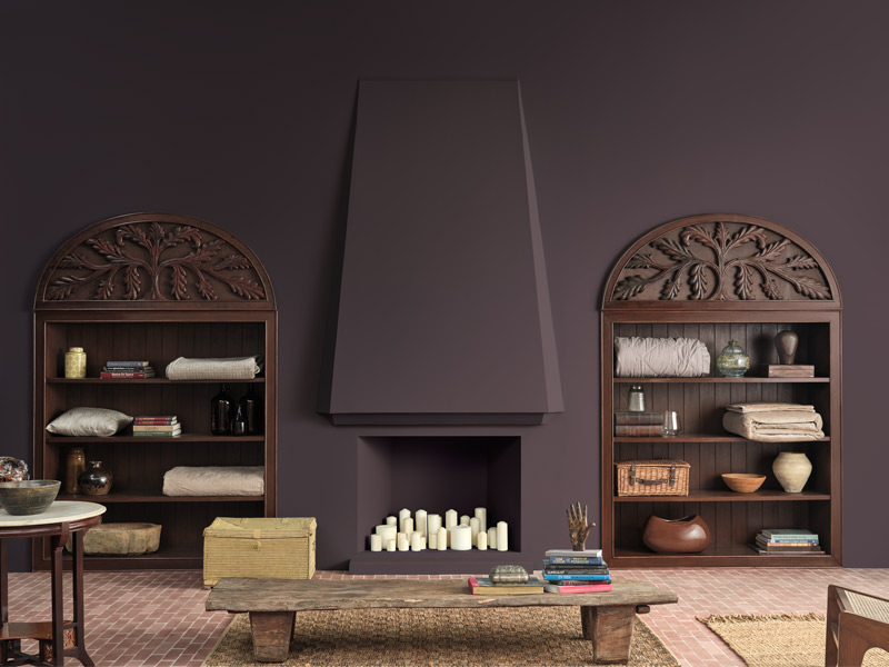 Teal living room with fireplace and carved wooden bookshelves – Beautiful Homes