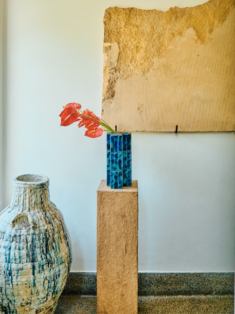 Stone artefact on the wall & a ceramic jar with blue tiles - Beautiful Homes