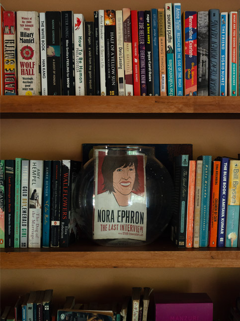 Bookshelf with stacks of books - Beautiful Homes