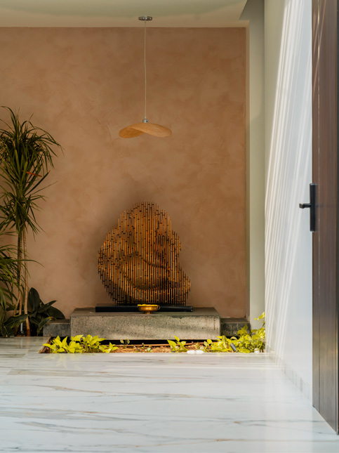 Sculptural metallic piece set against textured wall – Beautiful-Homes