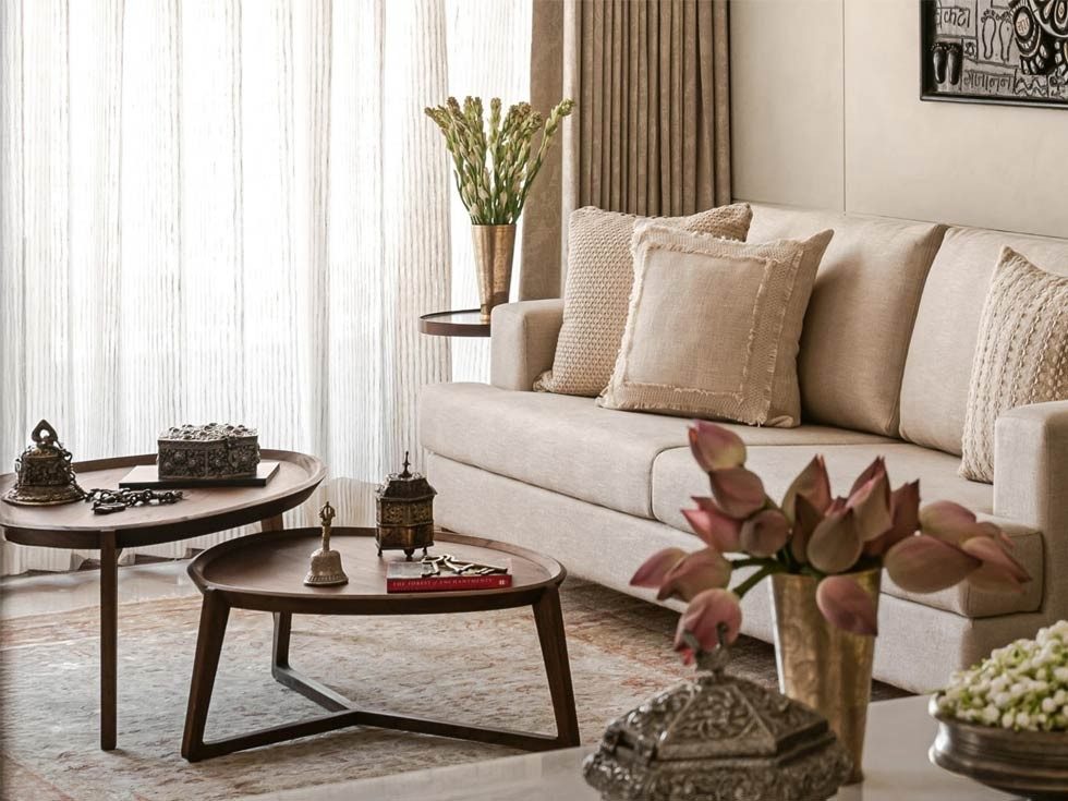 Wooden nesting tables and neutral sofa – Beautiful Homes