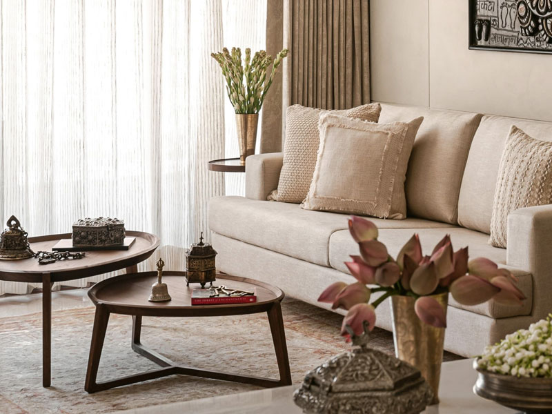 Wooden nesting tables and neutral sofa – Beautiful Homes