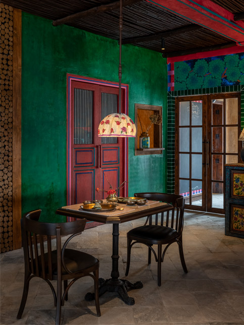 Shabnam Gupta's design for a mountain home features deep green walls, vermillion doors, vintage lighting, and hand-painted furniture – Beautiful Homes