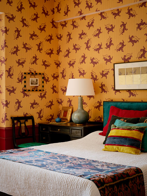 Pavitra's bedroom features a striking tiger-print wallpaper, layered textiles, jewel-toned accents, and a teal headboard – Beautiful Homes