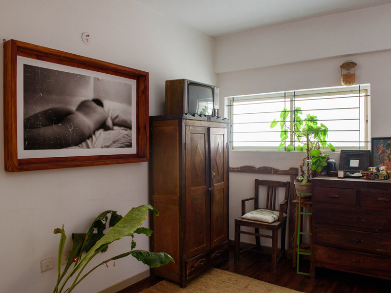 Eclectic Bedroom with Nude Artwork and Wooden Furniture – Beautiful Homes