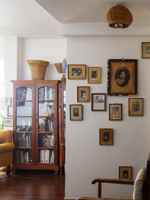 Living Room with Gallery Wall of Vintage Photos and Wooden Bookshelf Cabinet – Beautiful Homes