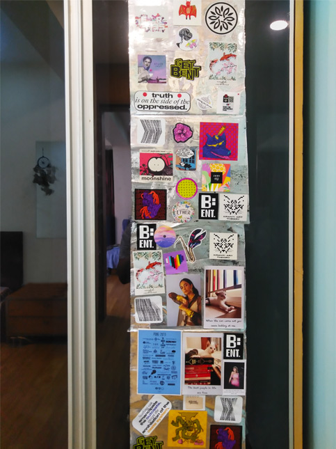 Eclectic wardrobe door adorned with stickers, quotes, and artwork – Beautiful Homes