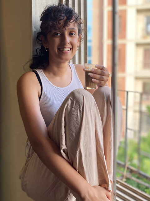 Young woman enjoying her morning coffee by the balcony window – Beautiful Homes
