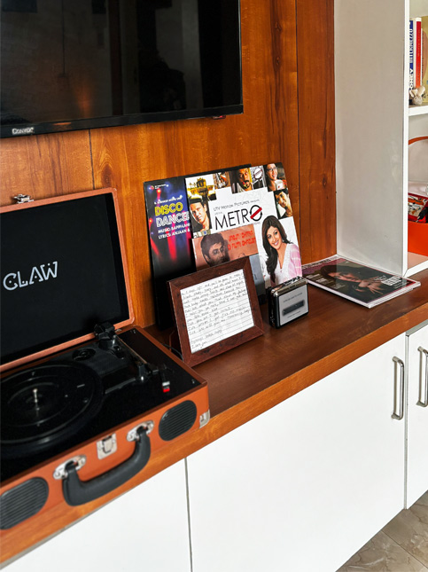 Retro-themed media corner featuring a record player, cassette tape, and Bollywood posters – Beautiful Homes