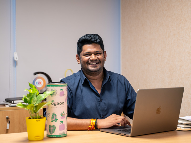 Siddhant bhalinge working at desk with Ugaoo plant and laptop – Modern Office Décor